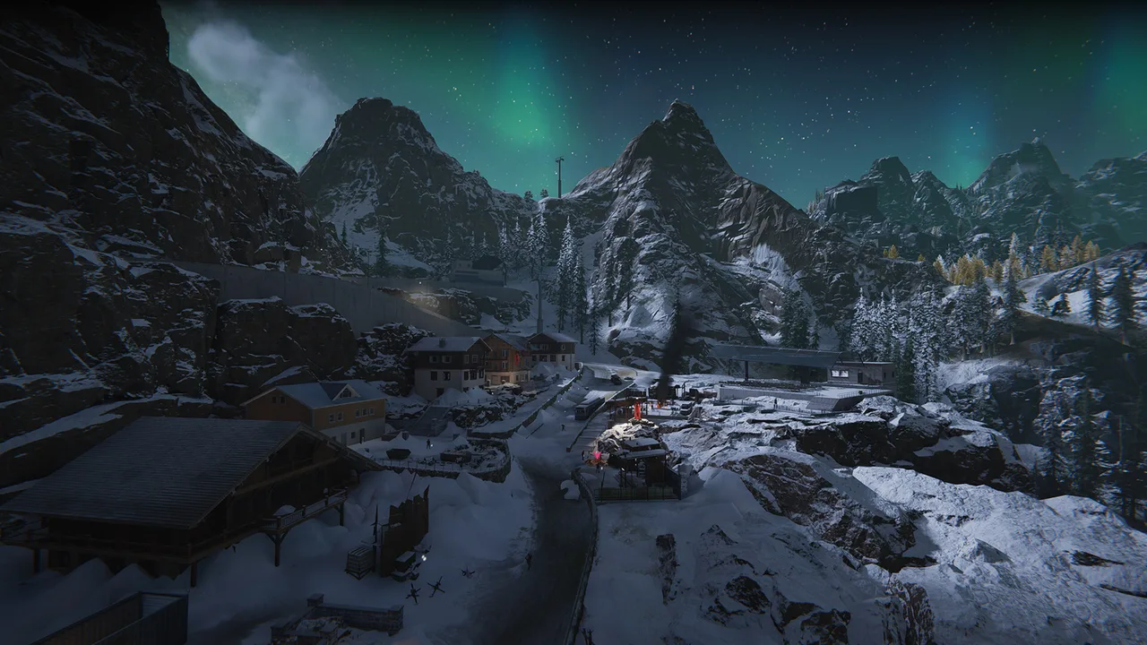 Snowy alpine village of chalets and a road beneath rocky mountain peaks, with green northern lights glowing in a starry night sky